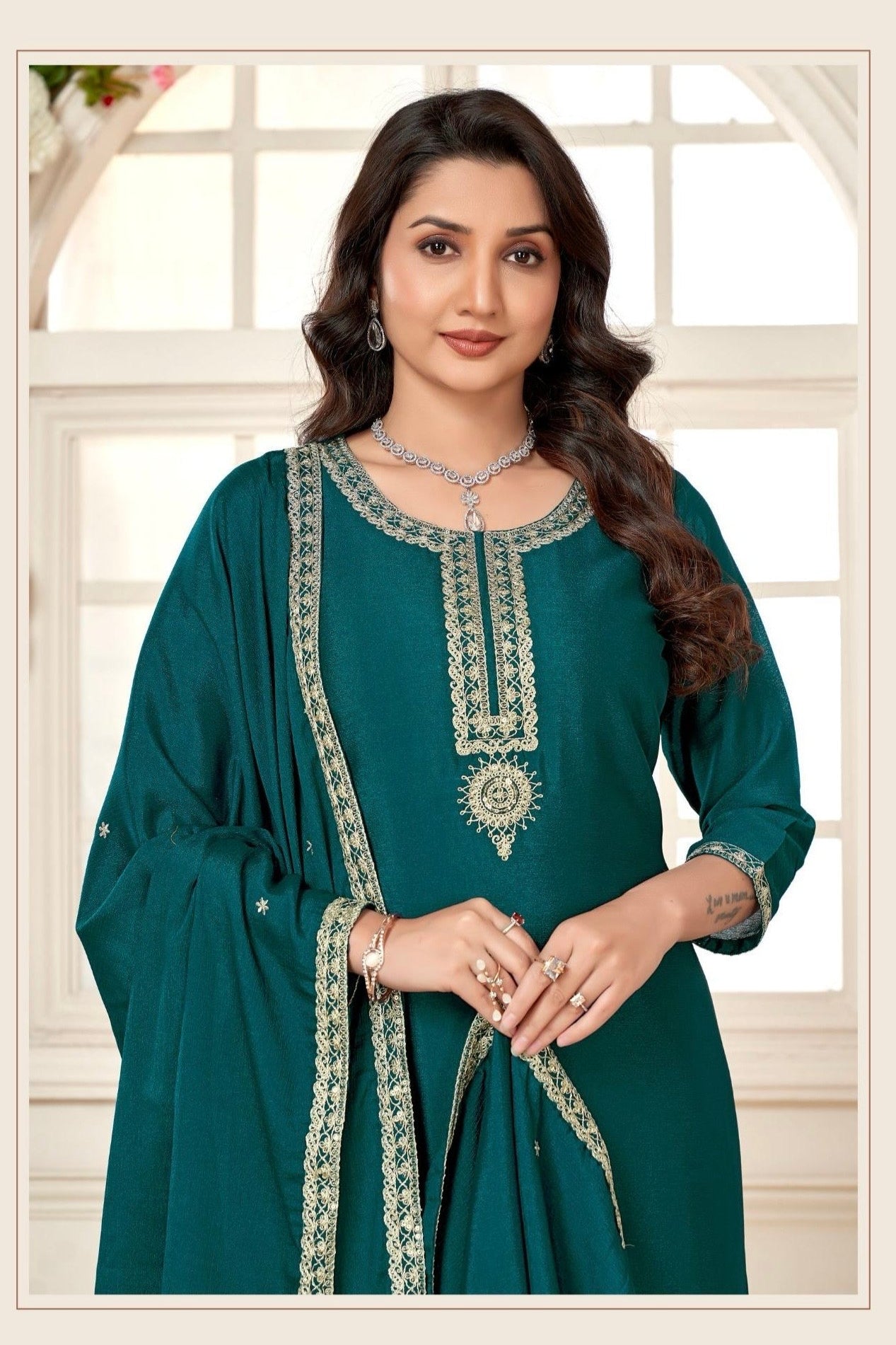 Woman wearing a teal traditional 3 piece suit