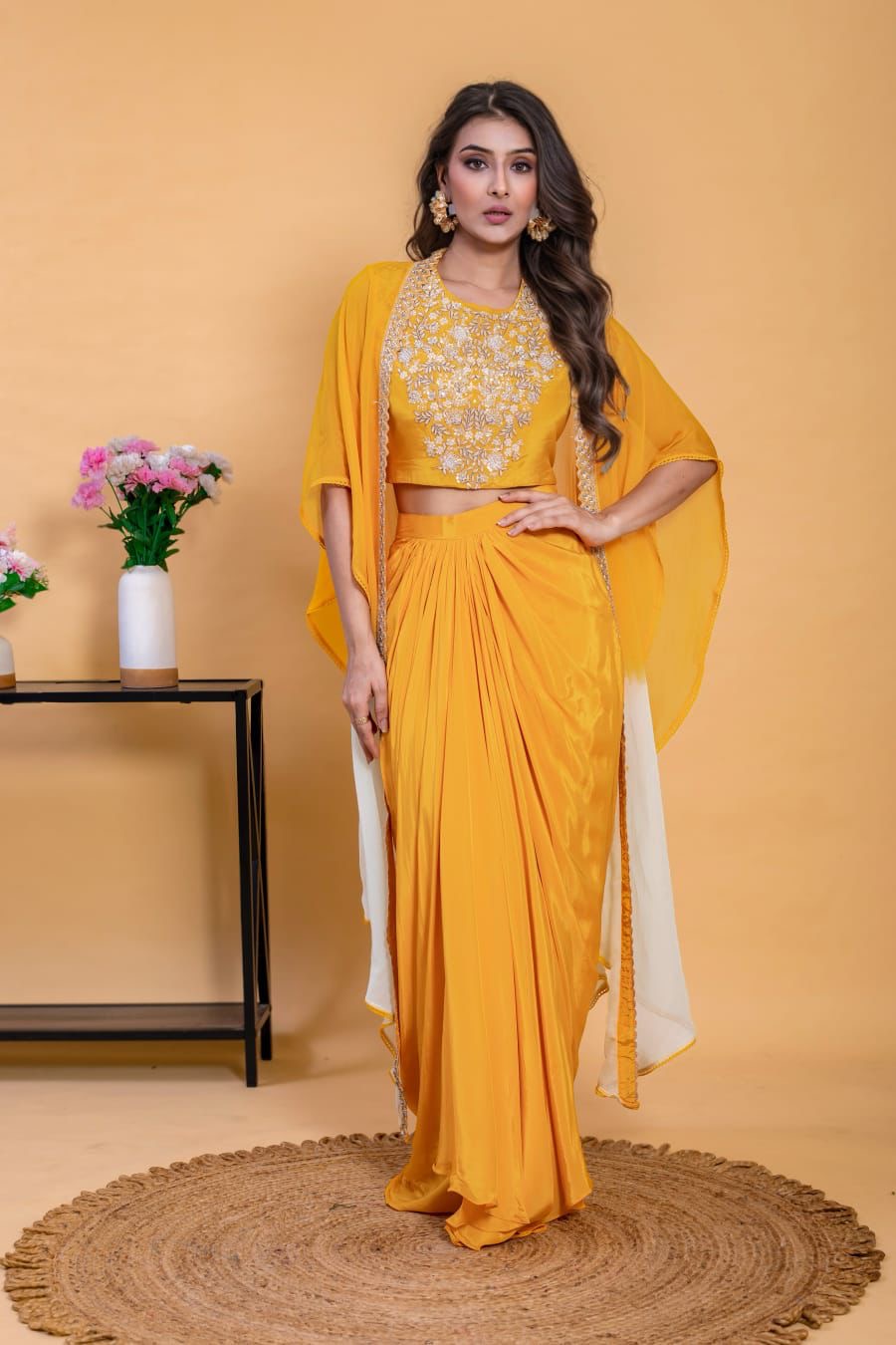This three-piece mustard yellow Indo-Western skirt set with cape is the perfect festive wear.
