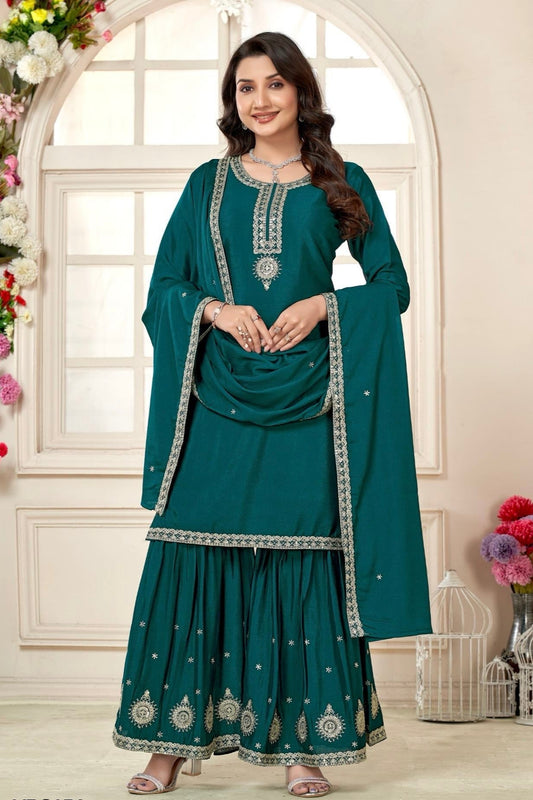 Woman wearing a teal traditional 3 piece suit 