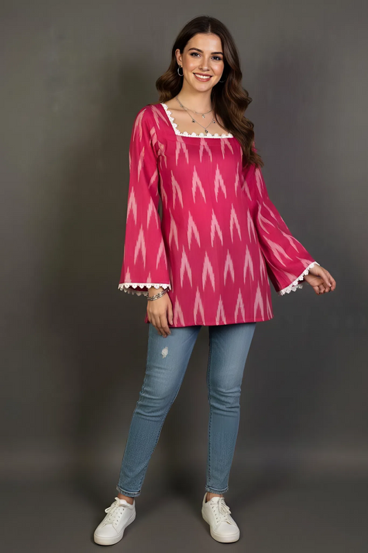 Full sleeve pink short kurti, It has a square neckline bordered with white lace and long bell sleeves