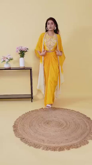 This three-piece mustard yellow Indo-Western skirt set with cape is the perfect festive wear.